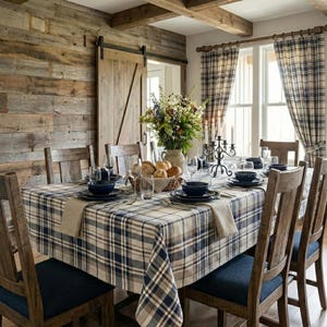 May include: A dining table set with a blue and beige plaid tablecloth, featuring dark blue ceramic bowls, clear glassware, a woven basket of bread rolls, and a floral centerpiece. Six wooden chairs with dark blue cushions surround the table.