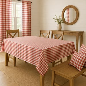 May include: A dining room set with a red and white checkered tablecloth, matching curtains, and throw pillows. The wooden table is surrounded by chairs and a bench. A round mirror hangs on the wall.