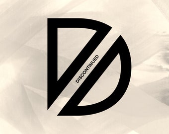 May include: Black and white graphic design of the letter "D" with the word "DISCONTINUED" written diagonally across the letter.