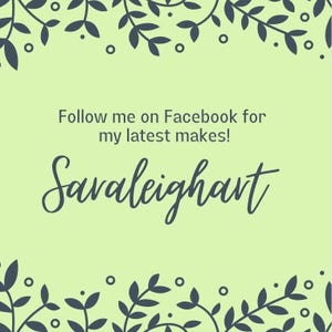 May include: A green background with a dark blue floral border. The text 'Follow me on Facebook for my latest makes!' and 'Saraleighart' is written in dark blue cursive font.