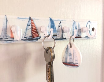 Wooden Key Holder.  Featuring Decoupage Sail Boats.  Four white hooks to keep your keys safe.