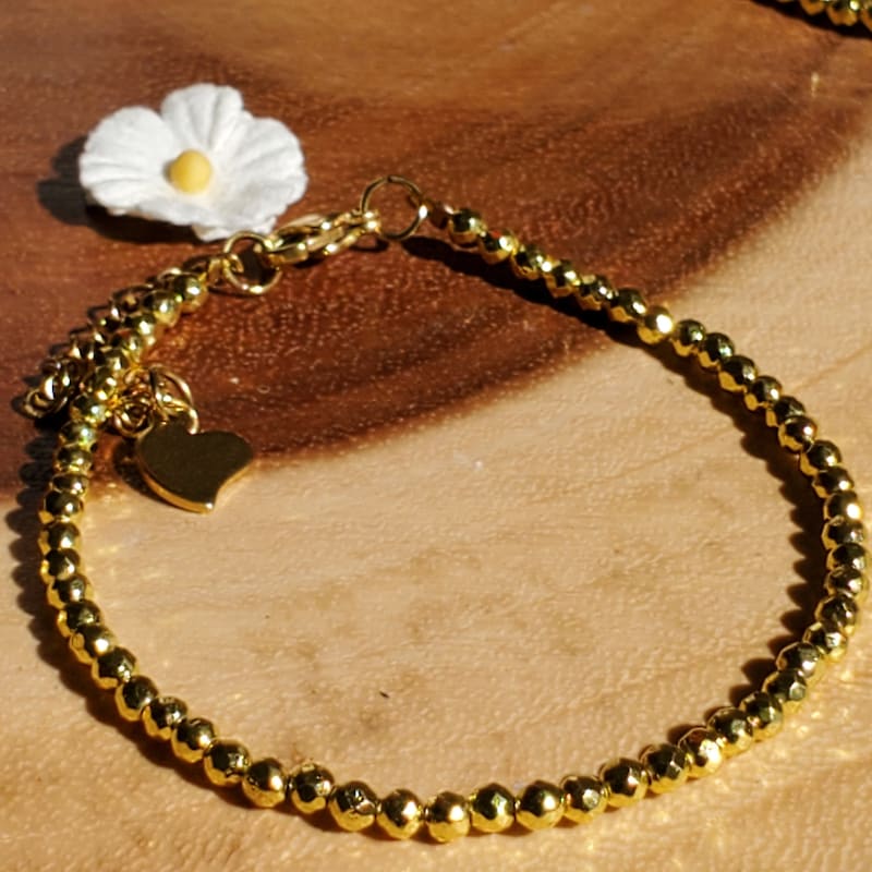 FACETED HEMATITE 2MM BEAD BRACELET W/ SMALL INSPIRE GOLD CHARM main image 1