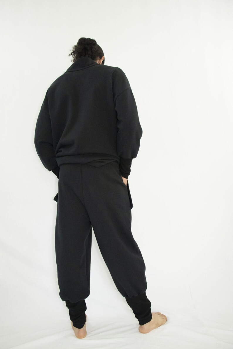 Man wearing black organic sweatpants with high rib cuffs by Carmen Calburean.