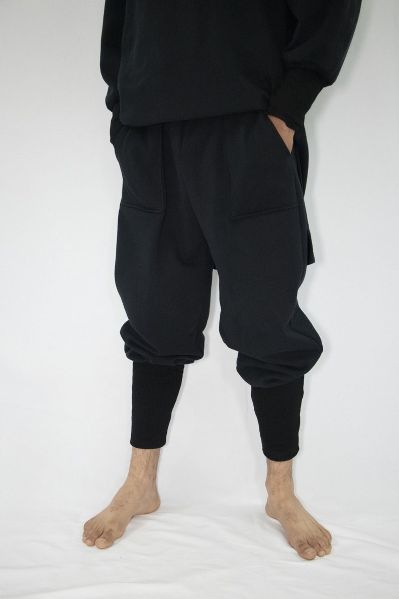 Man wearing black organic sweatpants with high rib cuffs by Carmen Calburean.