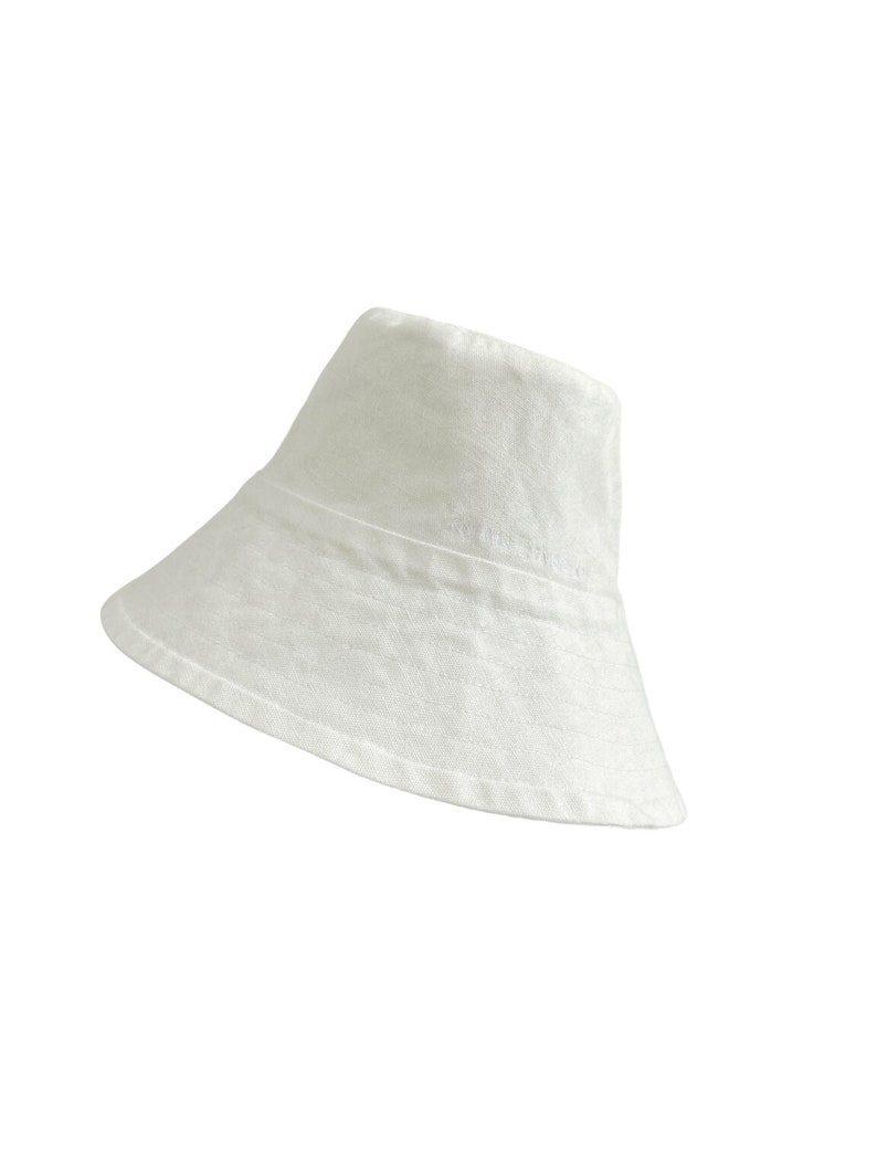 White organic Bucket hat with large brim and moon embroidered on top by Carmen Calburean.