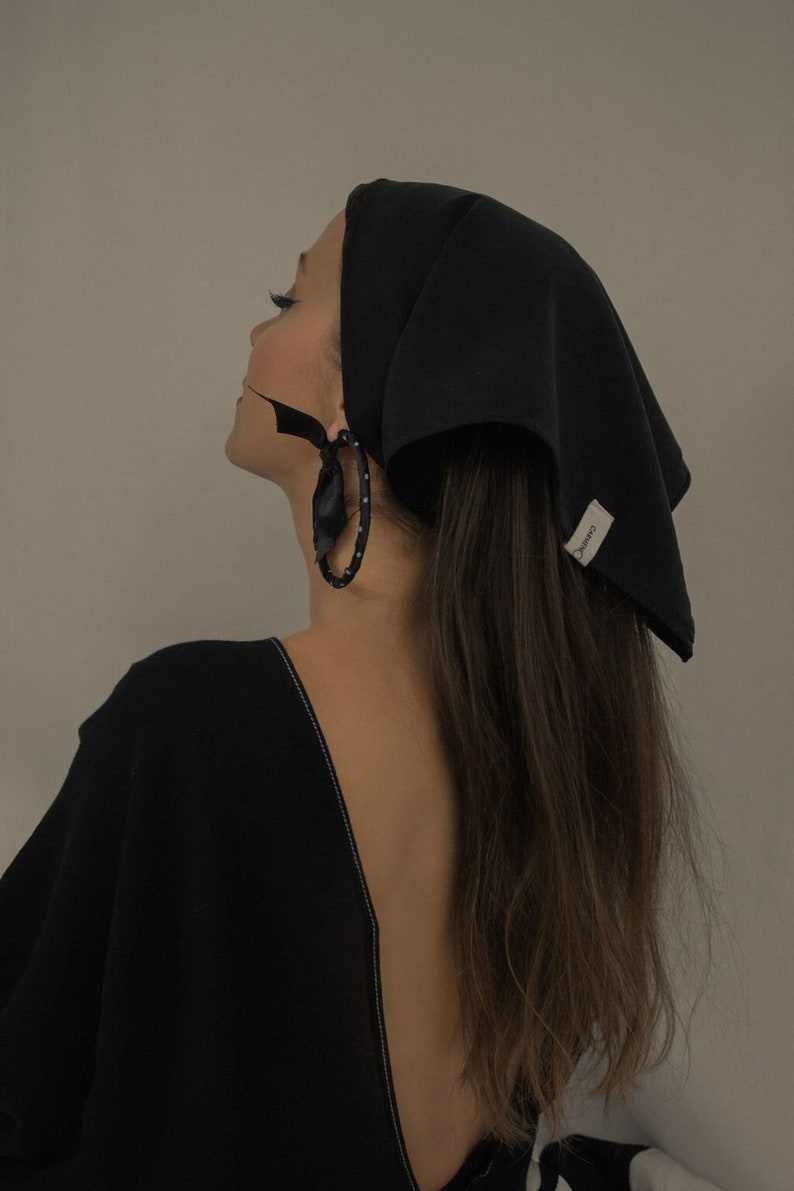 Girl wearing a black matte sustainable head scarf by Carmen Calburean.