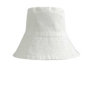 White organic Bucket hat with large brim and moon embroidered on top by Carmen Calburean.