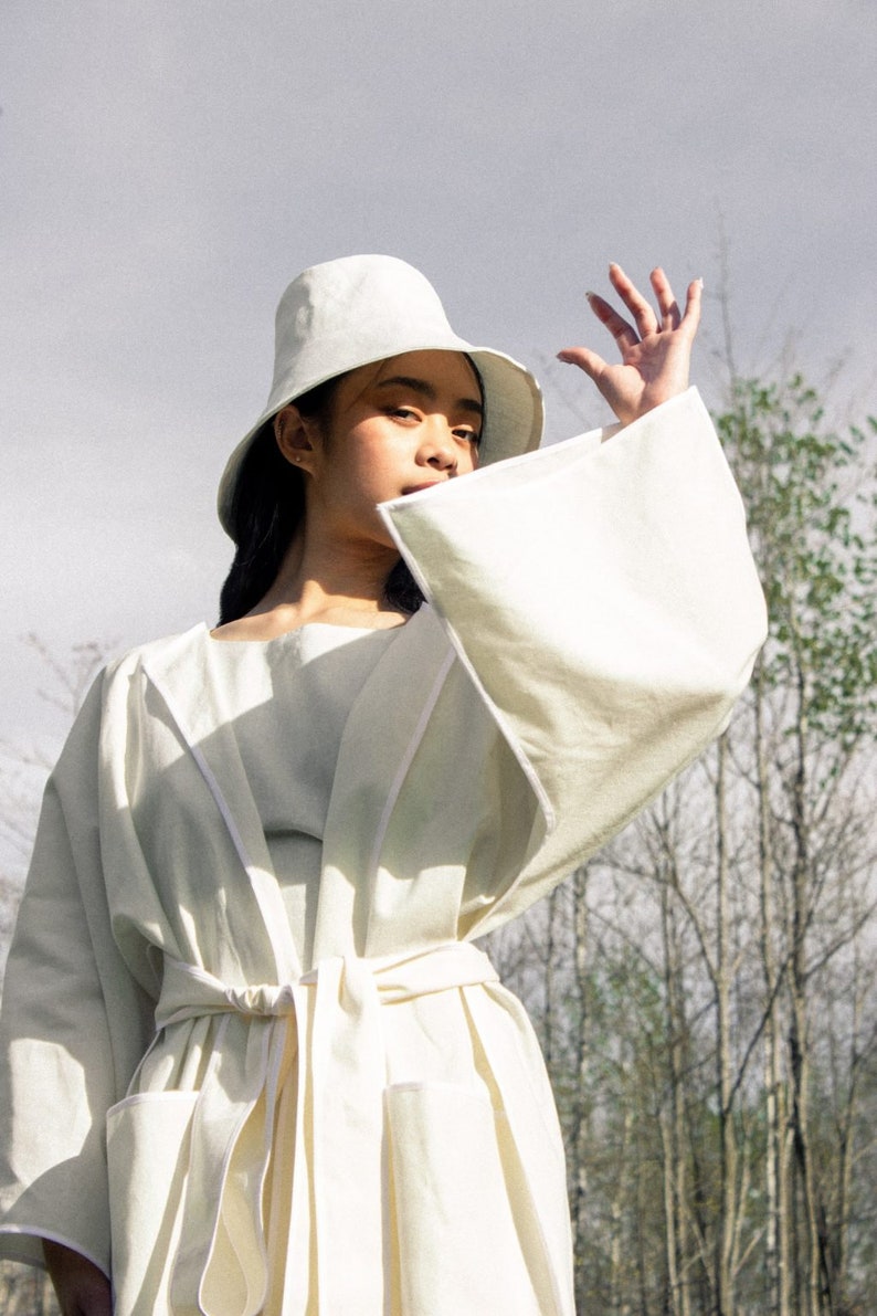 Girl wearing white Moon large brim bucket hat and dutch white kimono by Carmen Calburean.