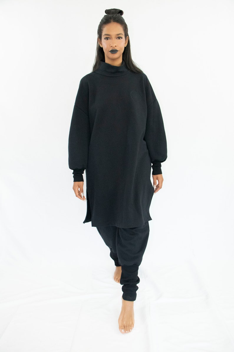 Woman wearing black organic sweatpants with high rib cuffs by Carmen Calburean.