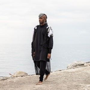 Man wearing black organic tracksuit with high rib cuffs by Carmen Calburean.