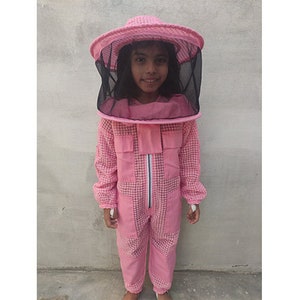 May include: A pink beekeeping suit with a matching pink hat and a black mesh veil. The suit has a zipper down the front and a checkered pattern.