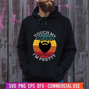 May include: A black hoodie with a vintage-style graphic that says "Touch My Beard And Tell Me I'm Pretty". The graphic features a beard with a rainbow background.