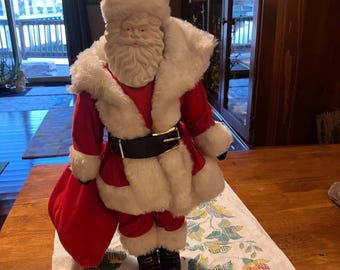 A Vintage Santa Claus Figurine with a stand