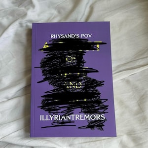 May include: A purple book with the title "A Court of Thorns and Roses" and the subtitle "Rhysand's POV: Illyrian Tremors" in yellow text. The cover features a black and white illustration of a bird.
