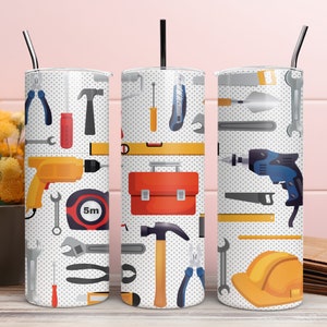 May include: Three white stainless steel tumblers with a pattern of various tools, including a hammer, screwdriver, wrench, tape measure, and a toolbox. The tumblers have a white background with a grey polka dot pattern.