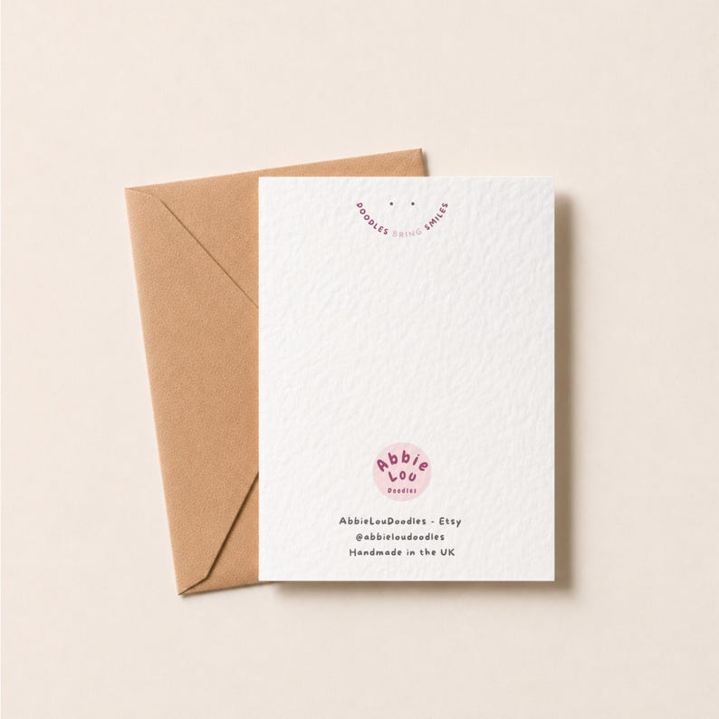 May include: A white greeting card with a textured surface and a brown envelope. The card features a pink circular logo with the text Abbie Lou Doodles, the phrase Doodles Bring Smiles, and the text AbbieLouDoodles - Etsy, @abbieloudoodles, Handmade in the UK.