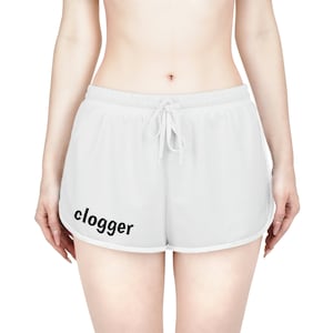 May include: White athletic shorts with a drawstring waist and the word "clogger" printed in black. The shorts have a curved hemline and a white trim.