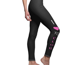 May include: Black leggings with the text "I ❤️ CLOG" in white and pink. The leggings are form-fitting and have a white seam along the waist and ankles. The image shows the leggings from the knee down.