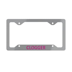 May include: A silver license plate frame with the word "CLOGGER" in bright pink lettering. The frame has four mounting holes and a rectangular shape, designed to fit a standard UK license plate.