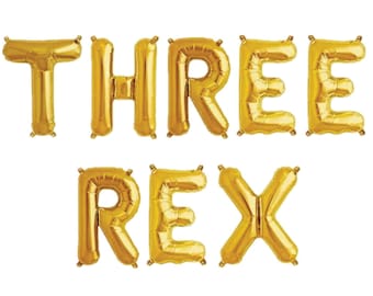 May include: Gold foil letter balloons spelling out "THREE REX".