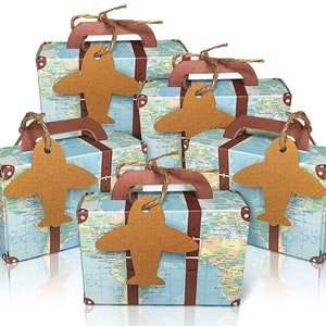 May include: Five small brown cardboard boxes shaped like suitcases with a world map design and brown paper airplane tags. The boxes have brown handles and are tied with twine.