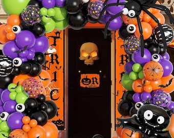 May include: A Halloween balloon arch with black, orange, green, and purple balloons. The arch is decorated with bats, spiders, and a skull. The text "Trick or Treat" is visible on a banner.