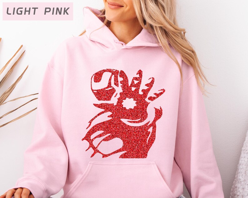 May include: Light pink hoodie with a red glitter design on the front. The design appears to be a stylized hand with a star in the center. The text "LIGHT PINK" is in a rectangular box in the upper left corner.