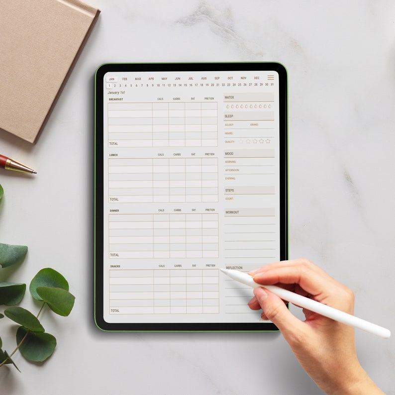 May include: A digital tablet with a green border displays a daily planner app. The app has sections for breakfast, lunch, dinner, snacks, water, sleep, mood, steps, workout, and reflection. The tablet is on a white marble surface.