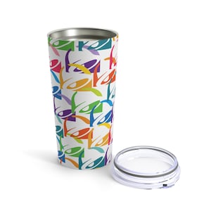 May include: A stainless steel tumbler with a white background and a colorful pattern of Taco Bell logos. The tumbler has a lid.