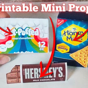 May include: Printable mini props for a dollhouse or miniature scenes. The props include a box of mini marshmallows, a box of Honey Maid Grahams, and a Hershey's chocolate bar.