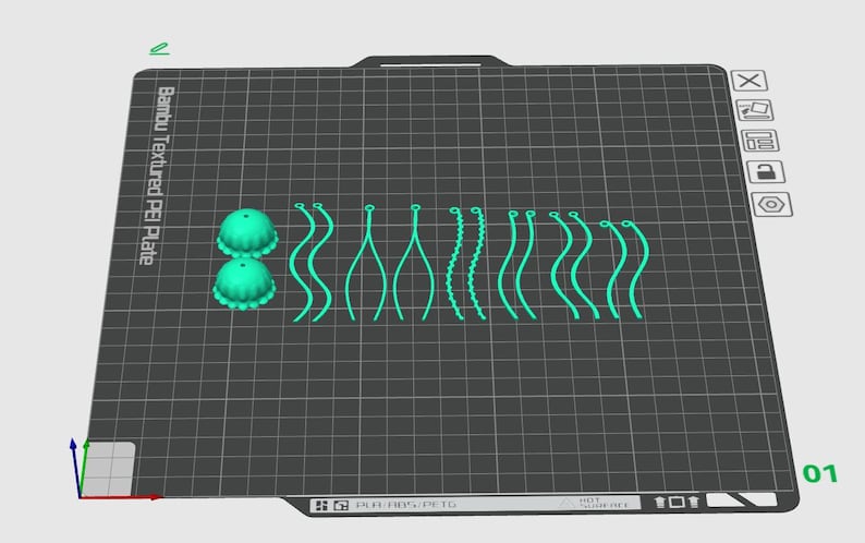 May include: A close-up of a 3D printed design on a textured black surface. The design includes two small green dome-shaped objects and a series of green lines and curves.