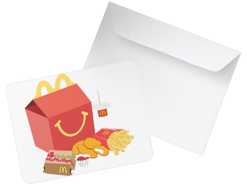 May include: A red and yellow McDonald's Happy Meal box with a smiling face, along with a cup, 4 Chicken McNuggets, a small box of fries, and a dipping sauce.