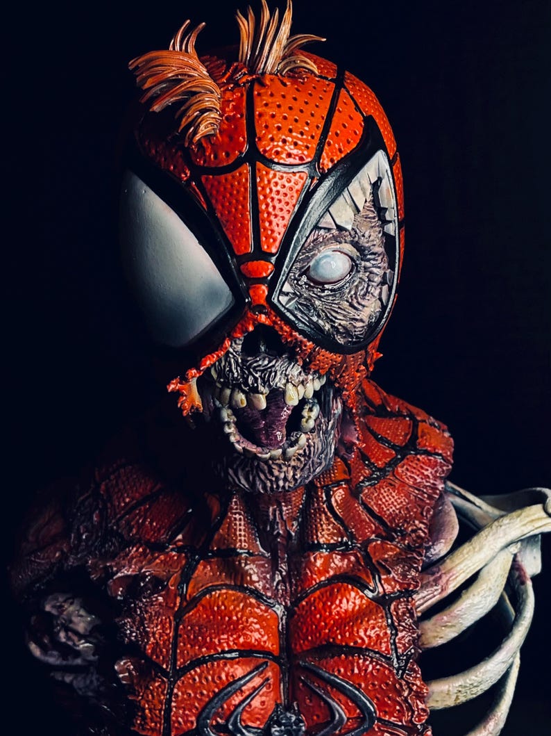 May include: A close-up of a zombie Spider-Man bust. The bust is made of painted resin and features a detailed sculpt of Spider-Man's head and torso. The bust is painted in a red and black color scheme, with a white spider logo on the chest. The bust is also painted with a realistic zombie effect, with exposed bones and flesh.
