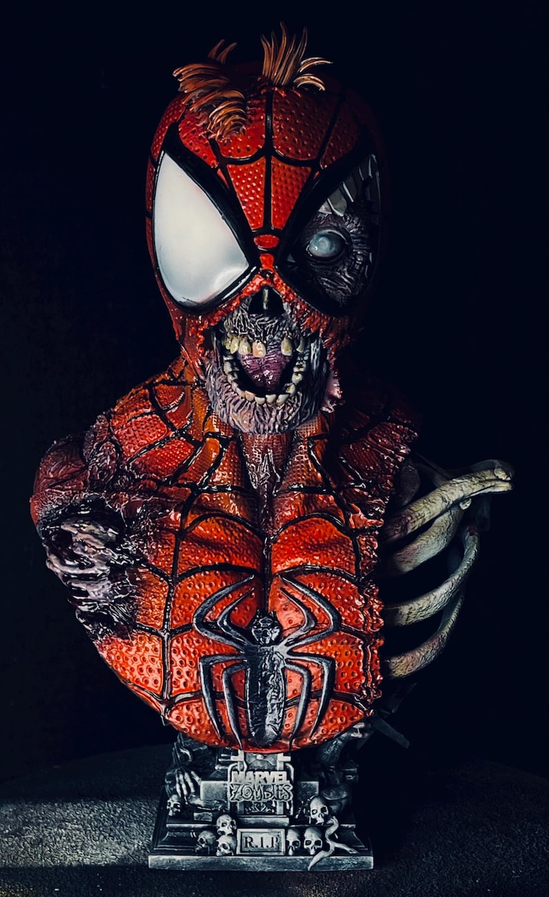 May include: A detailed bust of a zombie Spider-Man with a ripped, decaying red and black costume. The bust is mounted on a black base with a silver plaque that reads "Marvel Zombies R.I.P."