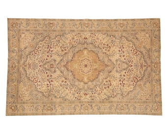 May include: A rectangular area rug featuring a central medallion design in shades of beige, tan, and cream. The rug is decorated with intricate floral and vine patterns in muted red and brown tones, enclosed by a detailed decorative border.