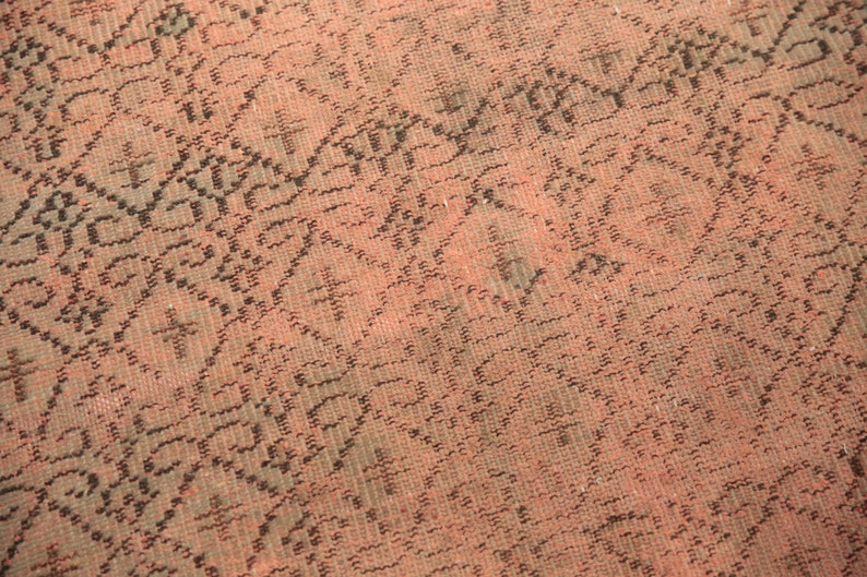 May include: Close-up of a pink and black patterned fabric with a woven texture.