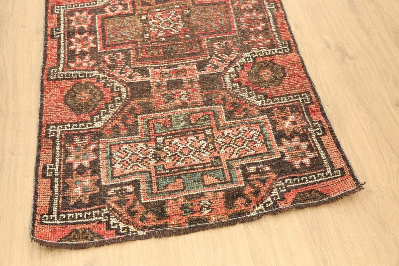 a colorful, intricately patterned rug or carpet placed on a wooden floor.