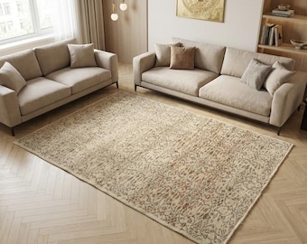 May include: A rectangular area rug featuring a distressed, vintage-inspired pattern in muted tones of cream, beige, and faded rust. The design consists of intricate, repeating floral and botanical motifs spread across the entire surface of the rug.