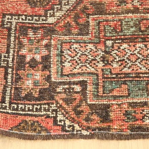 a close-up view of a colorful, intricately patterned rug with a variety of geometric shapes and designs.