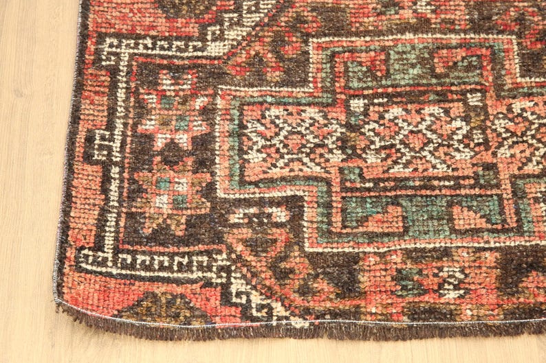 a close-up view of a colorful, intricately patterned rug with a variety of geometric shapes and designs.