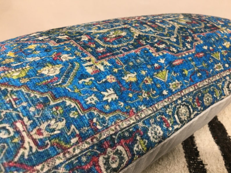 May include: A blue and red patterned throw pillow with a white border. The pillow has a traditional Persian rug design.
