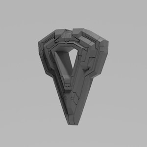 Puede incluir: Un objeto gris de forma geométrica con una punta puntiaguda y un gran centro abierto. El objeto está hecho de muchas piezas pequeñas rectangulares que están dispuestas en un patrón complejo.