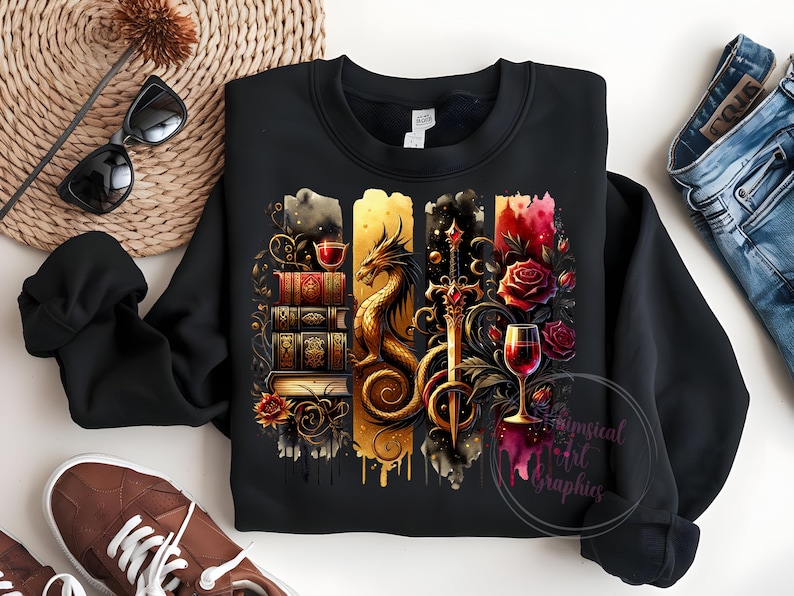 May include: Black sweatshirt with a graphic design featuring a dragon, a sword, a stack of books, and wine glasses. The design is in a watercolor style with gold, red, and black colors.