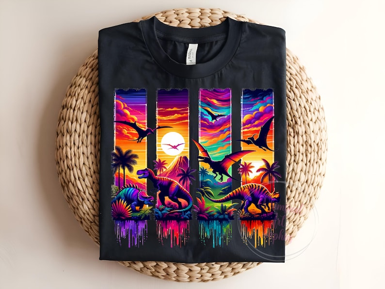 May include: Black t-shirt featuring a vibrant, colorful dinosaur design. The graphic includes various dinosaurs, palm trees, and a sunset scene with flying pterodactyls. The design is rendered in a vivid, rainbow-like palette.
