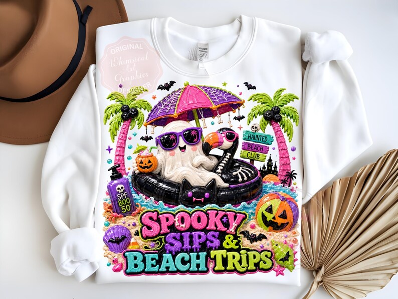 May include: White sweatshirt with a colorful graphic featuring a ghost wearing sunglasses, floating on a black inflatable flamingo, and the text "Spooky Sips & Beach Trips". Includes a pumpkin, palm trees, and bats.