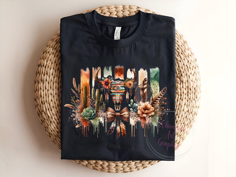 May include: Black t-shirt with a colorful graphic design featuring a skull with feathers, cacti, and flowers. The design has a watercolor effect and is dripping with paint.