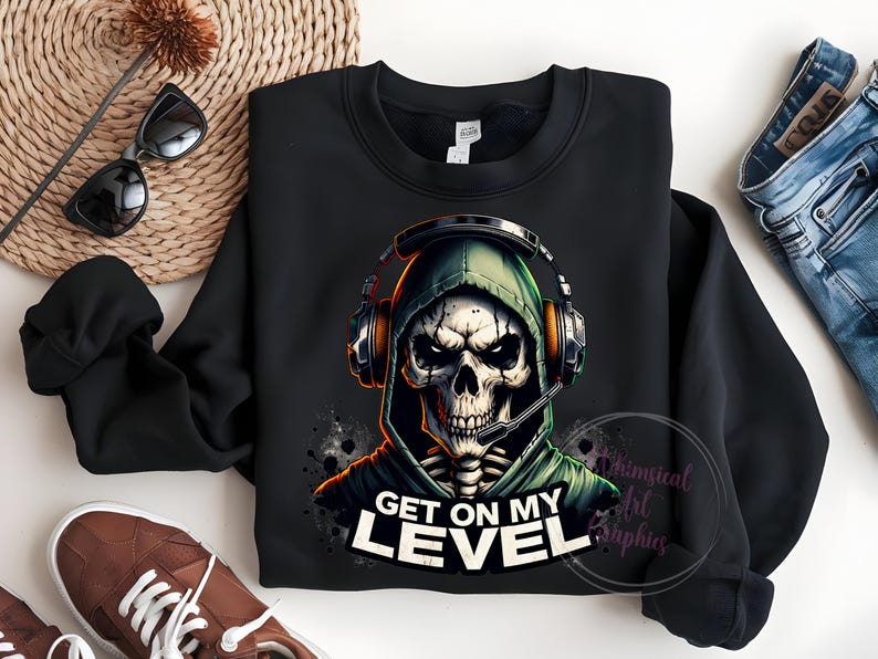 May include: Black sweatshirt with a graphic of a skeleton wearing a green hooded sweatshirt and headphones. The text "Get on my level" is printed below the graphic.