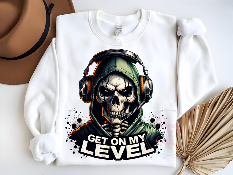 May include: White sweatshirt with a graphic of a skeleton wearing a green hooded sweatshirt and headphones. The text "Get on my level" is printed below the graphic.