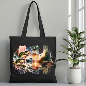 May include: Black tote bag with a colorful watercolor design of two bass jumping out of the water. The design also includes a sunset, trees, and a lake.