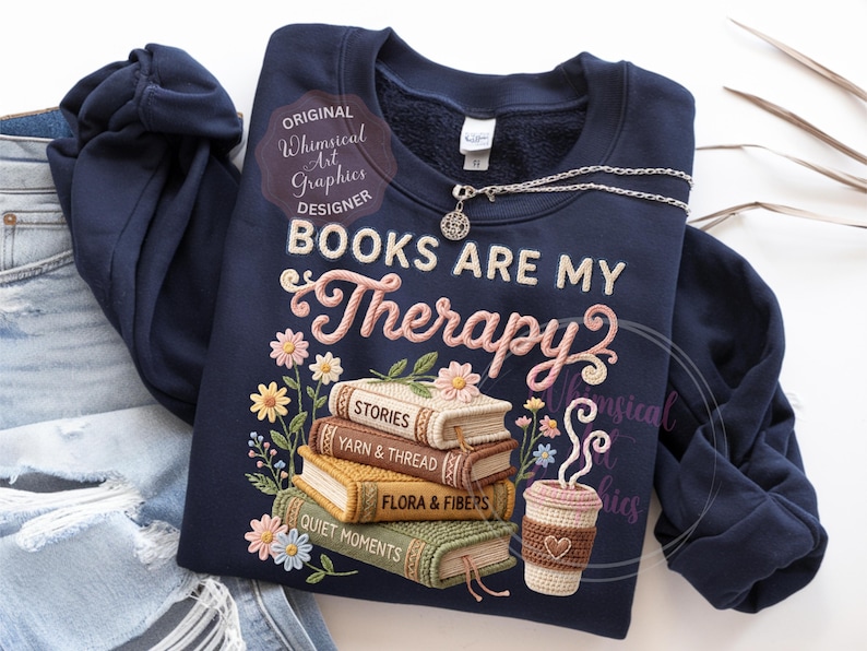 May include: Navy blue sweatshirt with the embroidered phrase "BOOKS ARE MY Therapy" and a stack of books with floral accents. A crocheted coffee cup and a silver necklace are also visible.